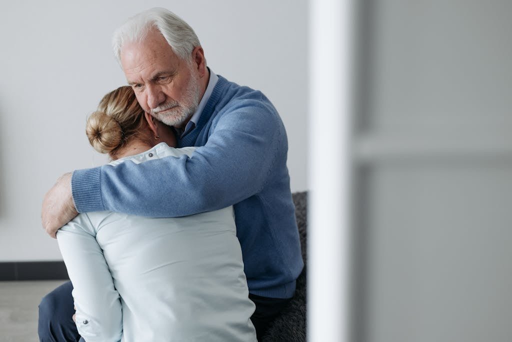 An Elderly Couple Consoling Each Other